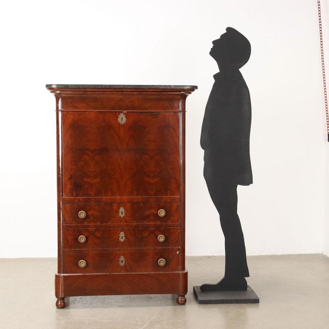 France, Charles The furniture made of oak is veneered in mahogany feather. Black marble top This piece is attributed to...