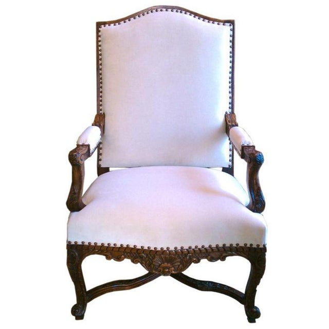19th century walnut Regence armchair with beautiful hand-carved details. New Upholstery of fine cotton velvet detailed...