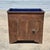 This is an antique American primitive dry sink made of distressed brown painted pine wood and fitted with a cobalt blue...