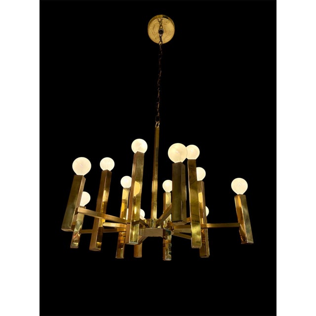 Gaetano Sciolari Brass Twelve Arm Chandelier from the 1970s. The solid brass square stock gives it a slightly more stout...