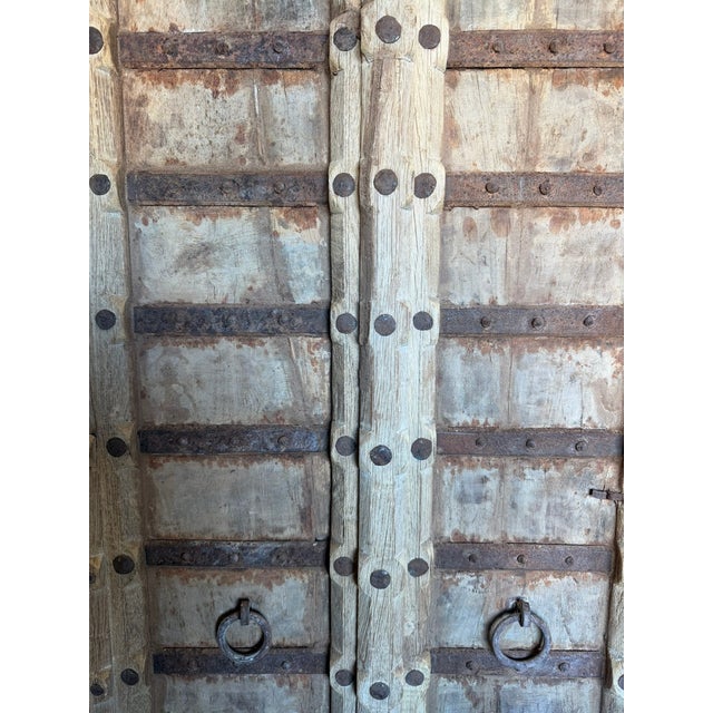 Elevate your entryway with this stunning antique Indian wooden door, rich in history and timeless craftsmanship. Hand-...