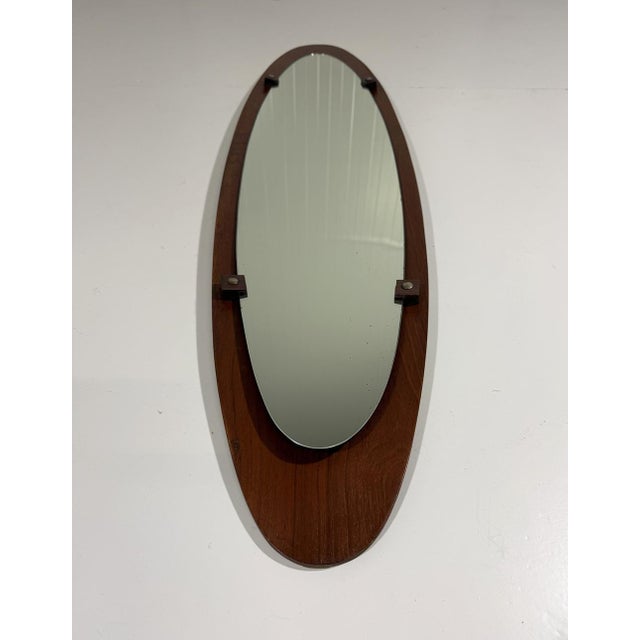 Beautiful wall mirror by Mobili Polli, Italy (marked). Oval in the length bended teak wooden back, oval mirror glas...