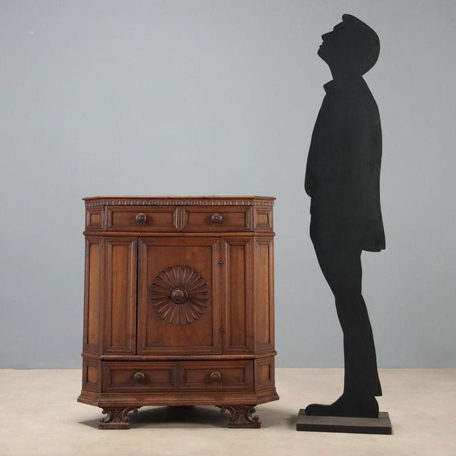 Baroque corner cabinet made from antique wood. Drawer under the top, door with a carved rosette surrounding the central...