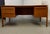Handsome teak executive desk by Danflex, Denmark, dating to the 1960s-70s. The desk features a sculpted "floating" top...