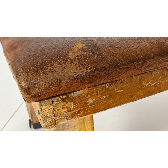 Decorative vintage gymnastic bench from the 1940s and 1950s. The robust cowhide leather and oak wood have a distinctive...