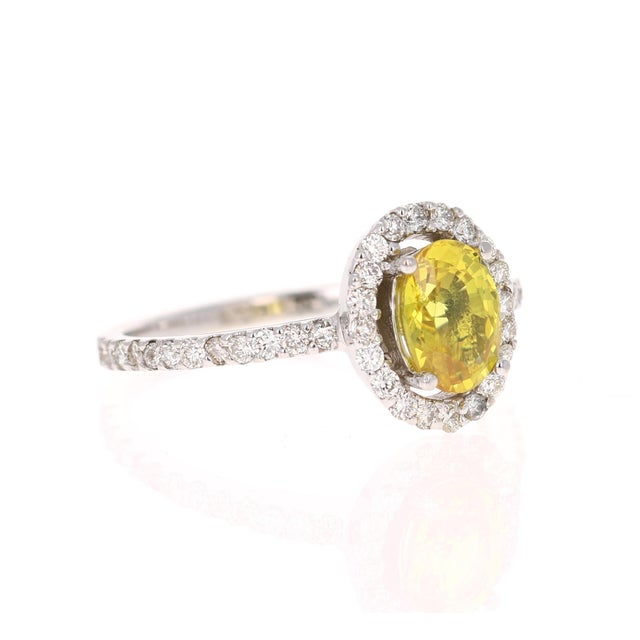 1.71 Carat Natural Yellow Sapphire Diamond Halo Ring 14 Karat White Gold This beautiful ring has a natural Oval Cut Yellow...
