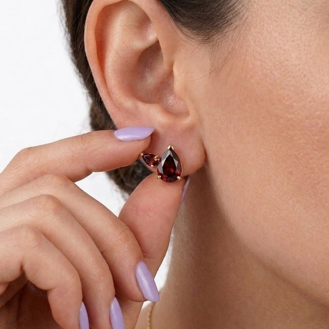 Add a touch of dramatic elegance to your everyday collection with this breathtaking pair of three-stone garnet cluster...