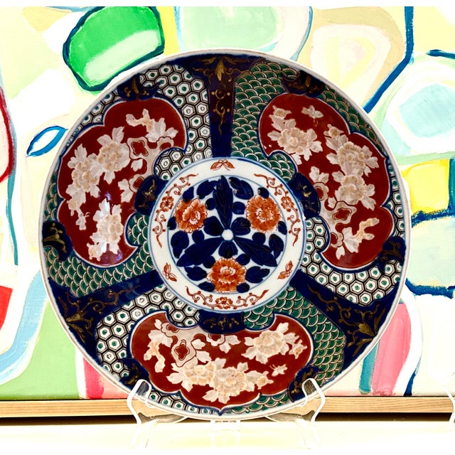 This striking vintage Japanese Imari charger features bold hand‑painted florals, deep cobalt panels, and richly patterned...