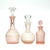 Blush pink perfume bottle curation, group of 3. A delicate group of blush pink and clear decanters with stoppers in a...
