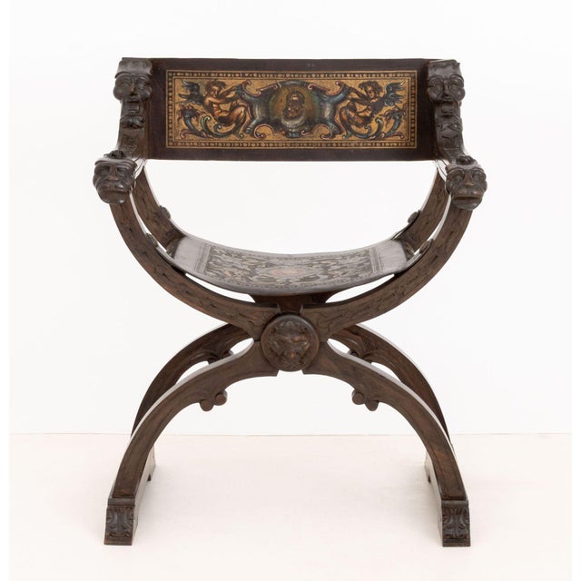 Renaissance Revival Walnut Savonarola Chair, carved mask heads and lion head to the arms, painted leather sling seat on...