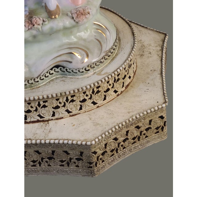 Illuminate your space with a touch of vintage charm using this Antique Figural Couple Statue Porcelain Boudoir Table Lamp....