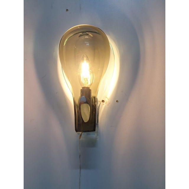 Pair of wall lamps with a chromed metal frame and diffusers consisting of two milled crystals. One in Nile green glass and...