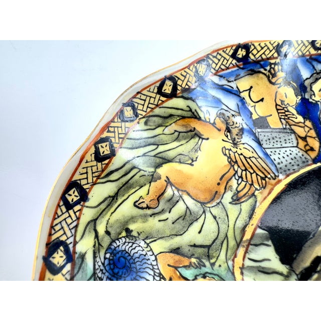 A striking mid-20th century ceramic plate inspired by Italian Renaissance majolica, richly decorated with a central...