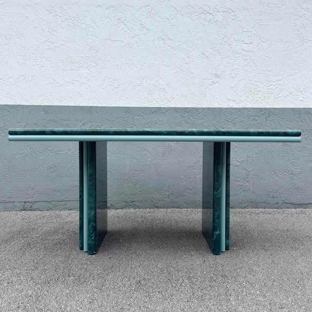 A striking Postmodern dining table showcasing a dramatic faux green marble laminate surface paired with soft sky blue...