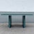 A striking Postmodern dining table showcasing a dramatic faux green marble laminate surface paired with soft sky blue...