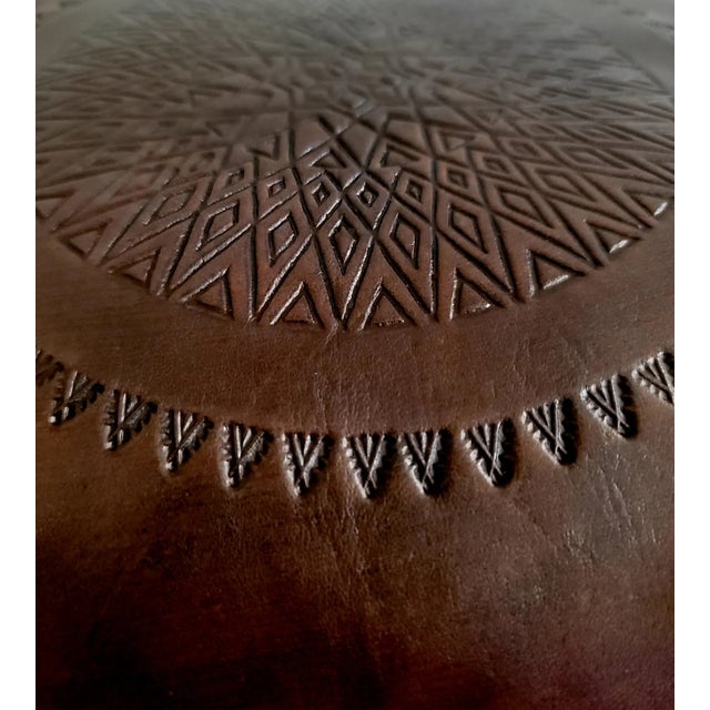 Handmade Moroccan camel saddle with genuine leather cushion and carved cedar wood base, measuring approximately 24 inches...