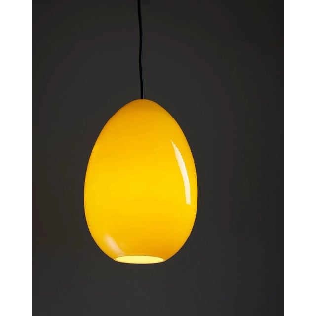 Introduce a burst of vibrant energy to your space with the Bright Yellow Oval Pendant by Luxus. This pendant light,...