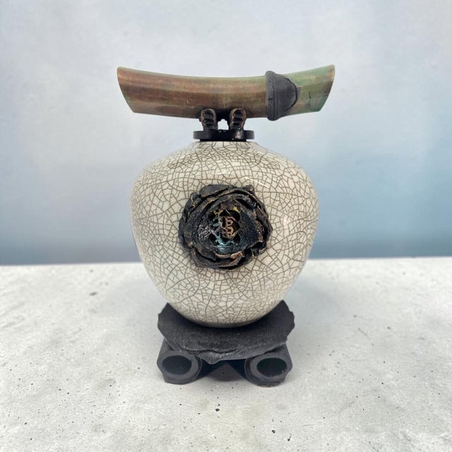 A 1999 Classic Wish Keeper by Hawaiian ceramic artist Matthew Lovein (b. 1949), combining raku-fired ceramic with a...