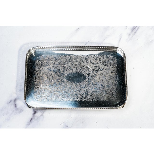 A refined expression of mid-century elegance, this exquisite circa 1940 vanity tray by The Sheffield Silver Co. embodies...