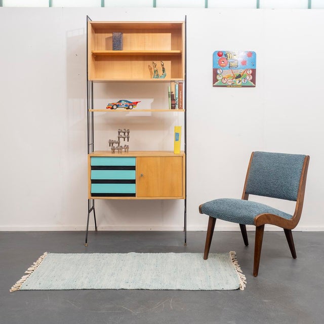 Freestanding shelving unit from the 1960s with black metal ladders. The striking ladders give the unit a timeless design....
