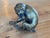 19th century Austrian bronze bulldog seated back on his haunches with one foreleg stretched forward, head cocked and...
