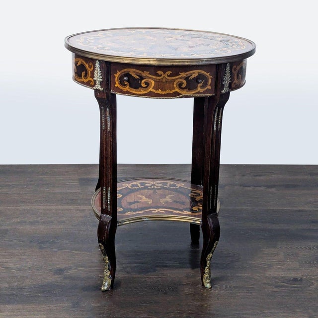 Antique side table using multiple woods with center inlay of birds, surrounded by metal trim. The table rests on curved...