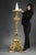 Important column tripod in carved and richly decorated gilded wood, forming a torch holder, in the louis xiv style. The...