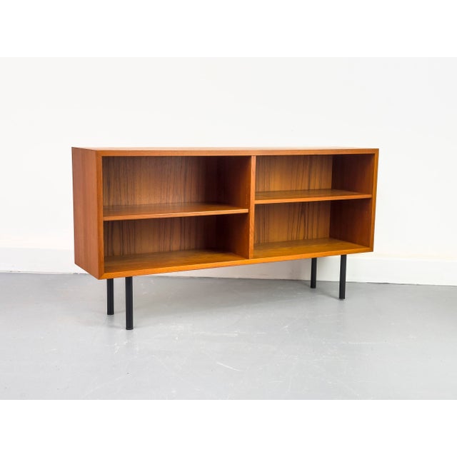Minimalist open sideboard, divided into two sections, each with an adjustable shelf. High-quality Danish production by...