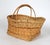 Vintage woven wicker and rush market basket w/ single top handle. No makers mark. Some breaks in wicker. Pictured.