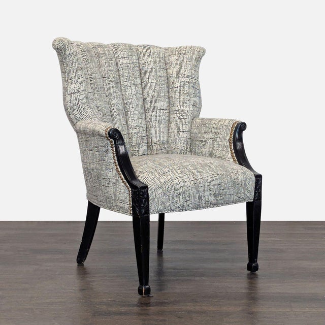 This lounge chair features a stylish, textured fabric with a fluted backrest and comfortable seat. The sturdy black wooden...