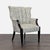This lounge chair features a stylish, textured fabric with a fluted backrest and comfortable seat. The sturdy black wooden...