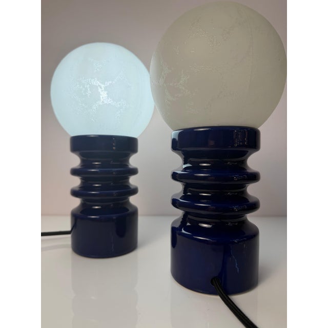 This original cari zalloni table lamp for dümler & breiden combines a striking dark blue ceramic base with a large,...