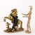 Gilt and burnished bronze sculpture depicting a tamer with a horse. The author's signature is inscribed on the base....