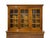 A Georgian style cherry wood bookcase or china cabinet with warm honey tones, molded cornice top, two-piece construction...