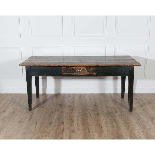 A characterful Swedish country kitchen table from the 19th century, retaining its original dark green painted finish with...