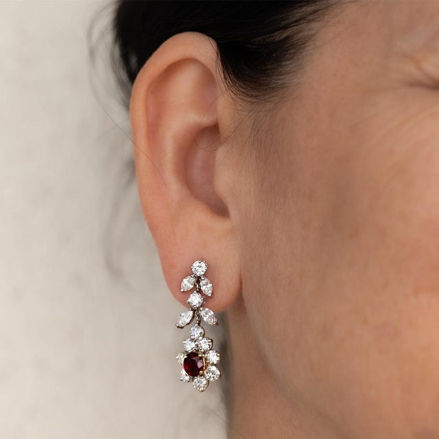 Platinum and 18k earring containing two very fine rubies weighing 2.46 carats and 20 modern round brilliant and 8marquis...