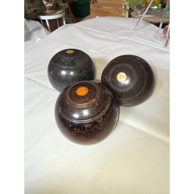 Collection of three beautiful antique European Lignum Vitae wood lawn bowling balls.