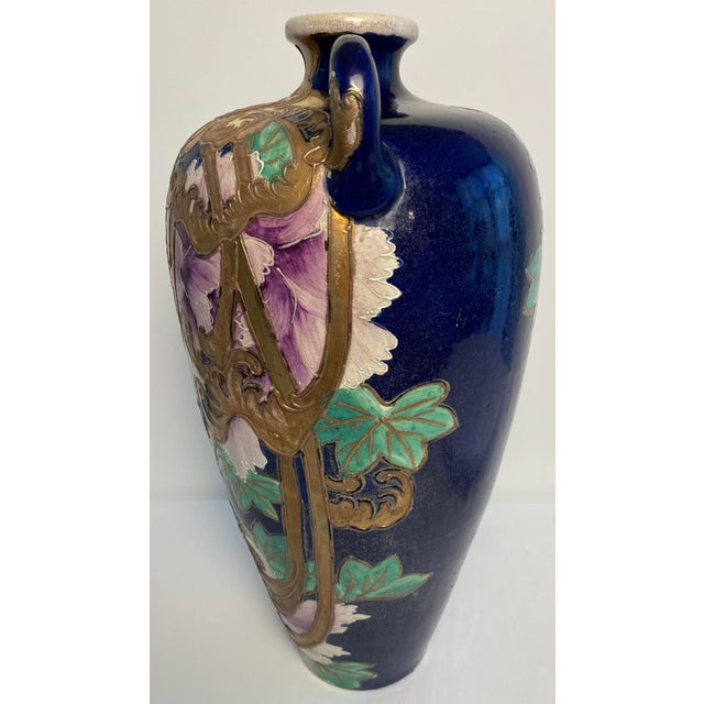 An unusual Japanese Satsuma-style moriage ceramic vase, richly decorated with a deep cobalt-blue ground, large hand-...