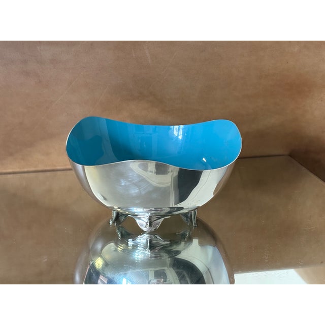 Striking vintage Heirloom silver-plated bowl featuring a polished exterior contrasted by a vibrant turquoise blue enamel...