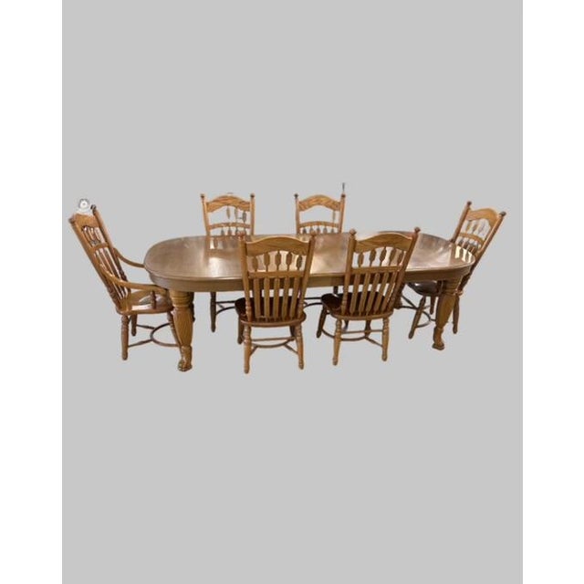 Virginia House Oak Dining Set with Six Chairs Two of which are Captains Chair . Table has Claw Feet Legs .Table is 102...