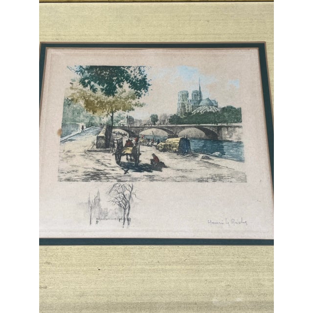 Early 20th century hand-colored etching of the Pont Neuf bridge on the Seine River in Paris, with Notre Dame Cathedral in...