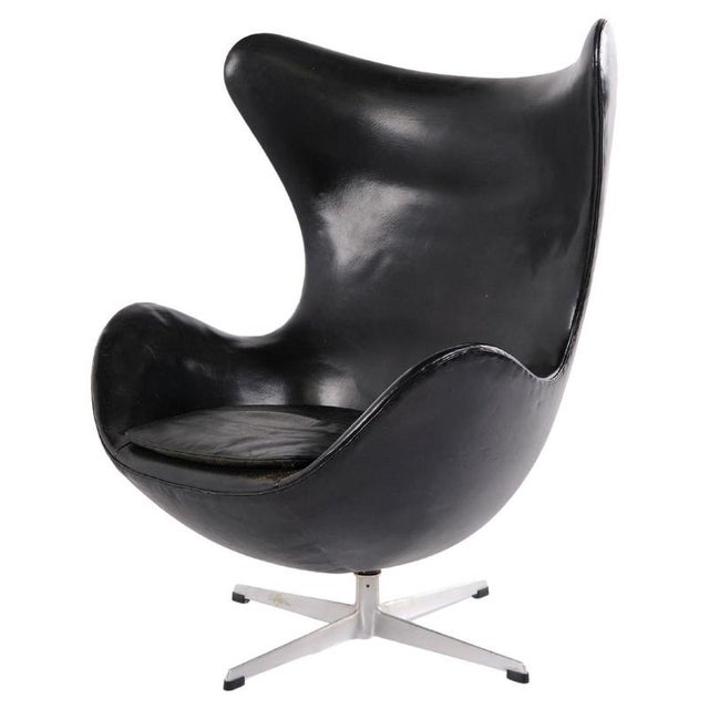 Egg chair designed by arne jacobsen and produced by fritz hansen. Early model upholstered in black original leather and...