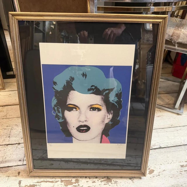 This striking 21st-century lithograph presents a captivating reimagining of the British supermodel Kate Moss, executed in...