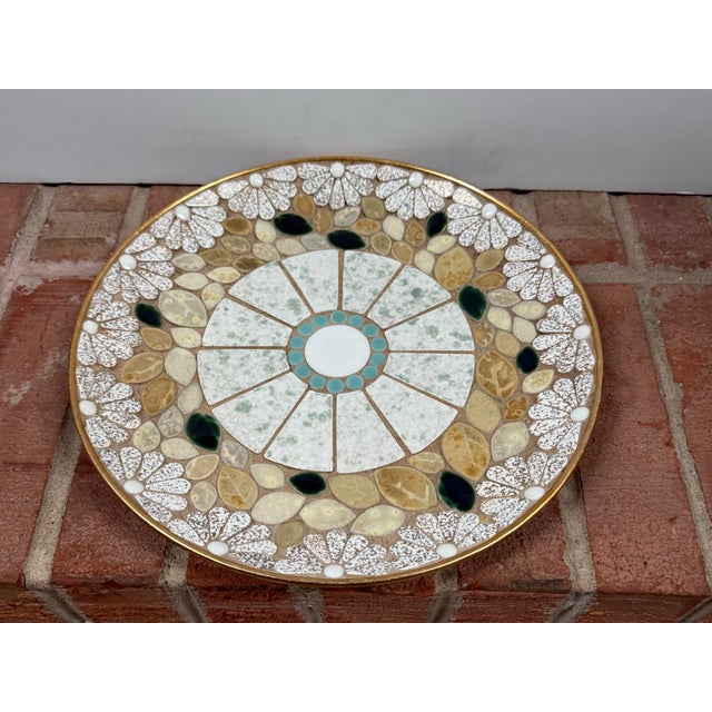 Vintage Mid-Century Modern mosaic ceramic tiled decorative plate features a central geometric pattern with white and...