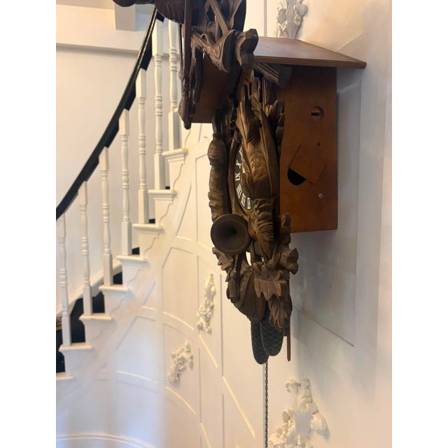 A magnificent antique Black Forest carved walnut cuckoo clock dating from around 1900, beautifully hand carved in the...