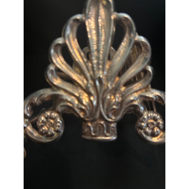 Elevate your table setting with the timeless drama of the Italian Baroque. This exquisite, silver-plated knife rest by...