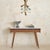 A 1950s Italian console table, defined by its fluted wood façade. Gently curved vertical detailing creates a rhythmic...