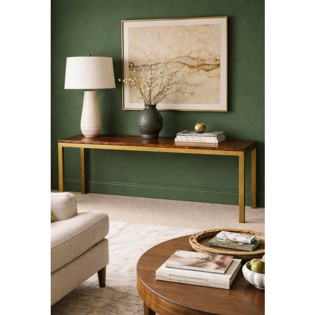 This is a 1970s modern brass console table with a dark burl walnut top. It was manufactured by Tomlinson and is marked. It...