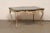A French carved and painted wood table (or desk), with shapely legs and top edges, from the 19th century. This antique...