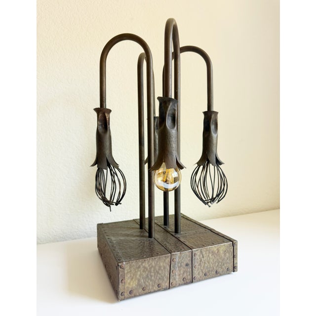 Industrial meets biophilic in this rare vintage light sculpture featuring a hammered bronze base and four curved arms with...
